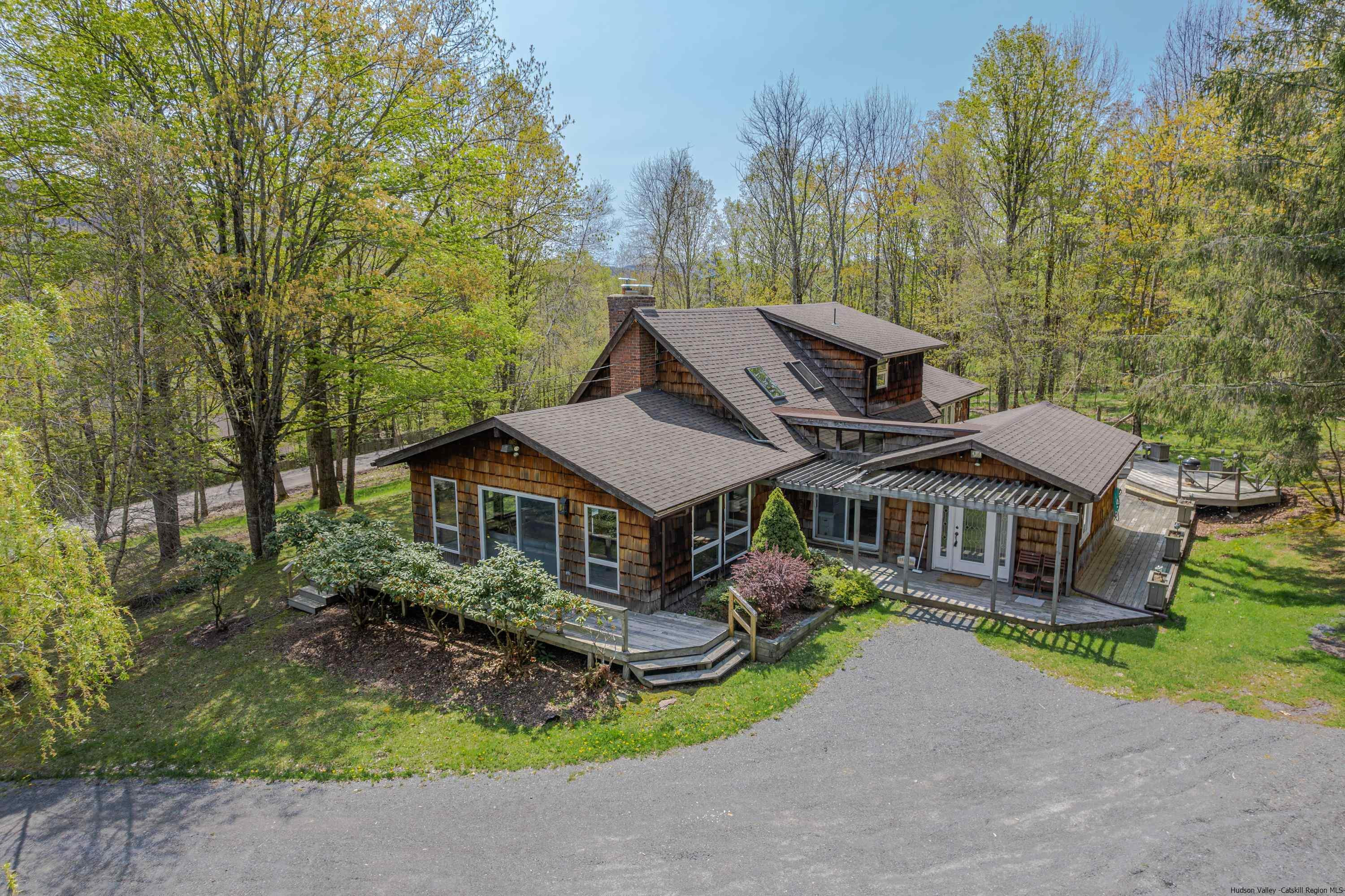an aerial view of a house with a garden and trees