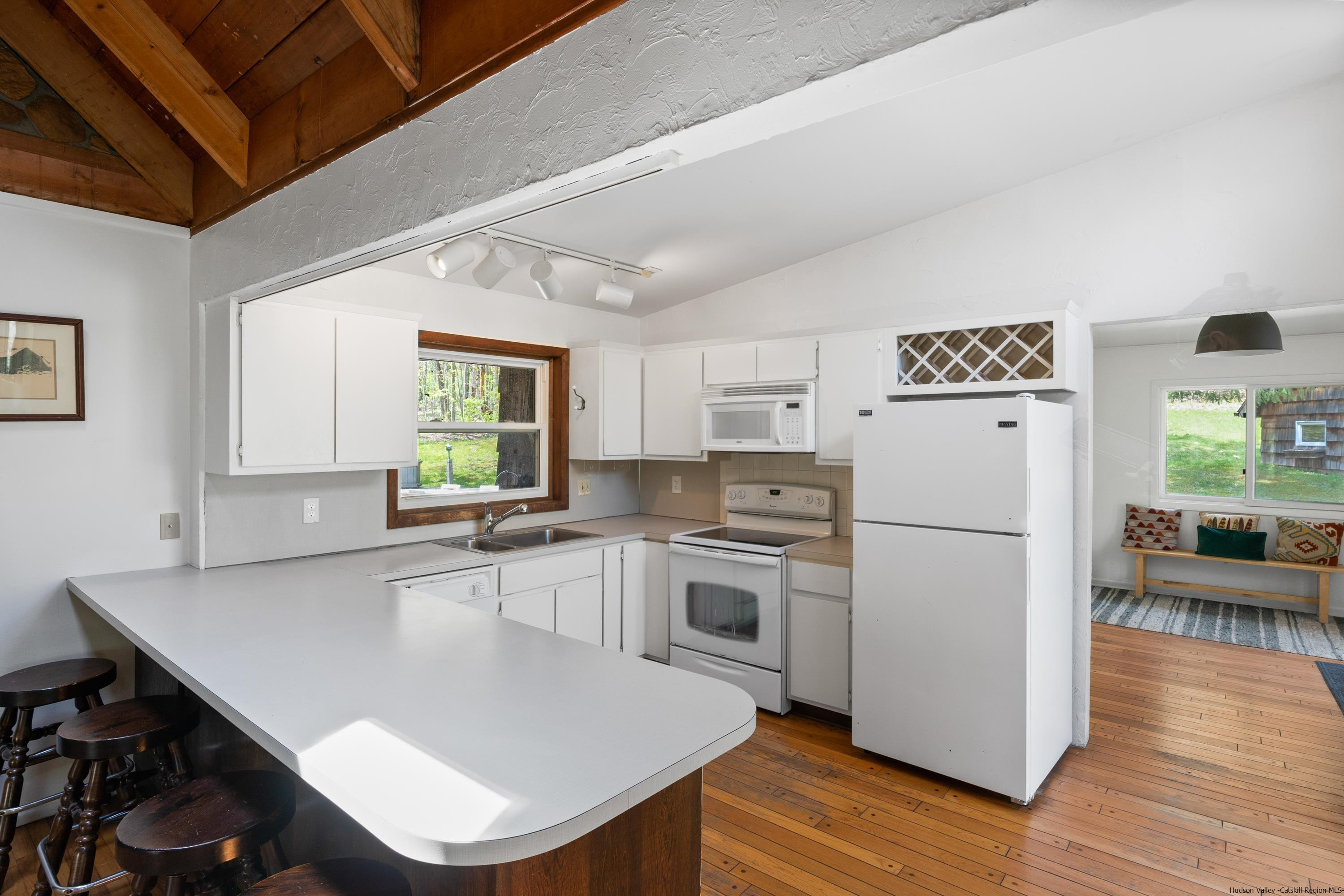 167 Old Towne Road Roxbury, NY 12421 - Photo 11 of 29 a kitchen with white cabinets and white appliances