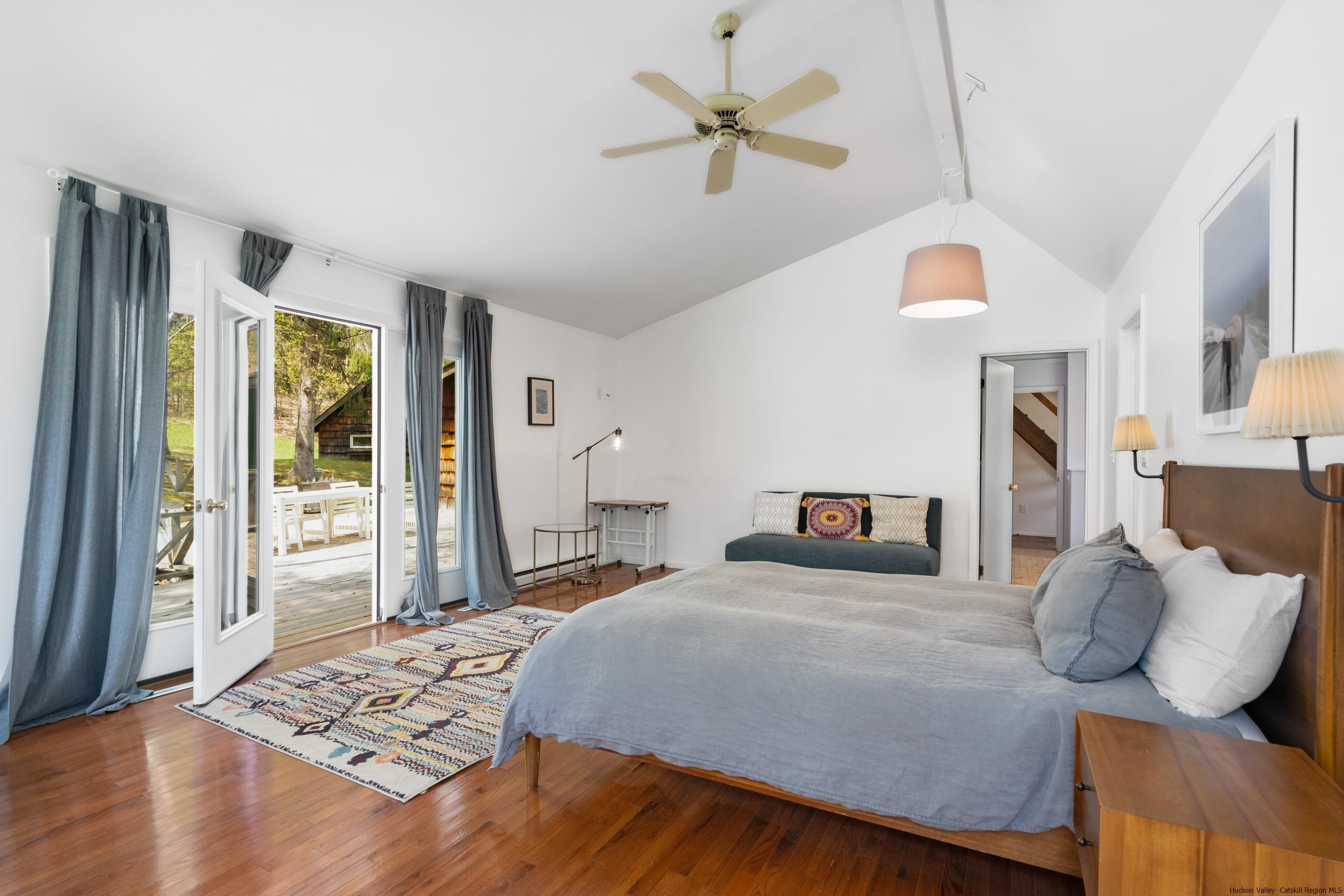 167 Old Towne Road Roxbury, NY 12421 - Photo 15 of 29 a bedroom with a bed and a chandelier