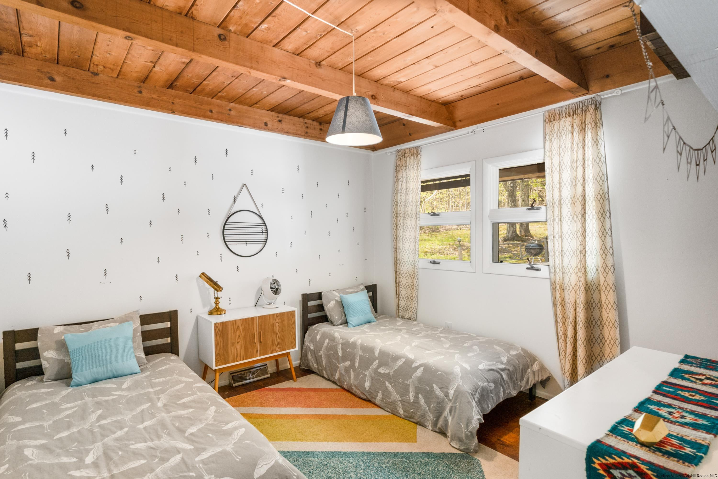 167 Old Towne Road Roxbury, NY 12421 - Photo 17 of 29 a bedroom with a bed a mirror and a window