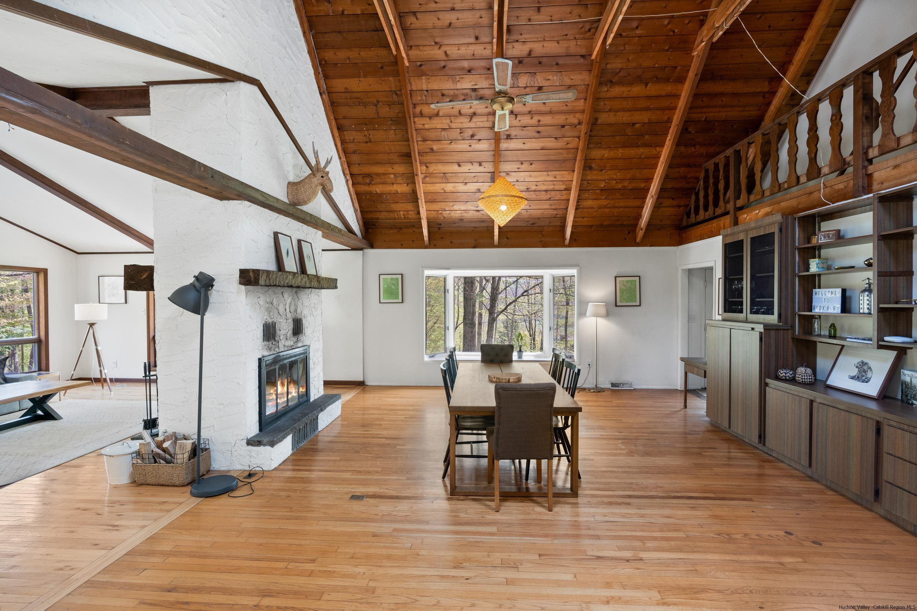 167 Old Towne Road Roxbury, NY 12421 - Photo 5 of 29 a view of a big room with wooden floor and windows