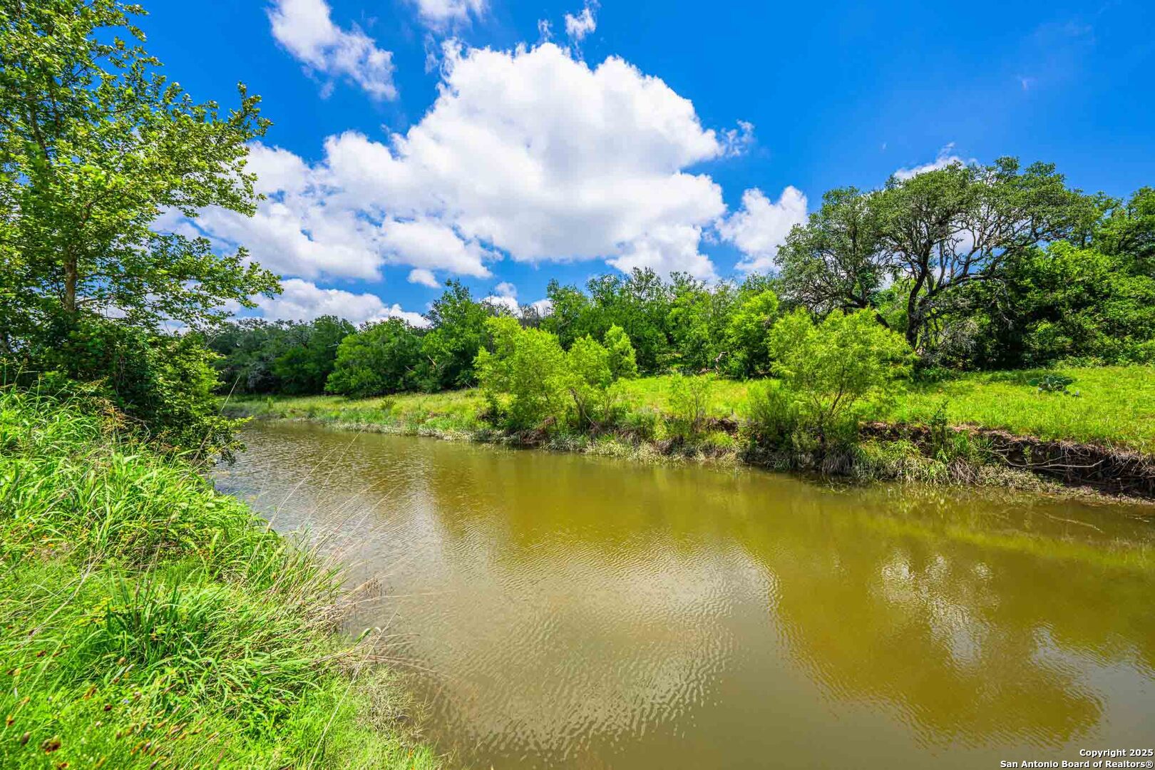 8 Cypress Creek Road Comfort, TX 78013 - Photo 33 of 39 a view of a lake with houses in the background