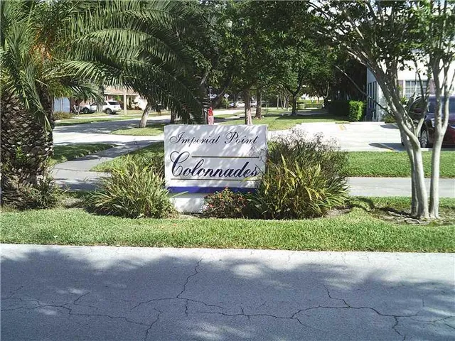a view of a park with a bench and trees