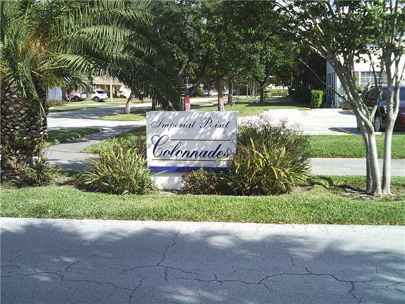 a view of a park with a bench and trees