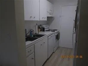 a kitchen with cabinets appliances a sink and a window