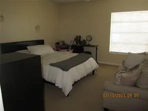 a bed sitting in a bedroom next to a window