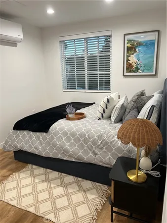 a large bed sitting in a bedroom next to a window