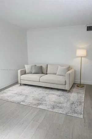 a living room with furniture and a lamp