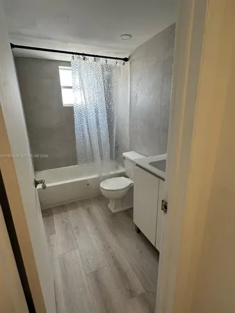 a bathroom with a shower and a toilet