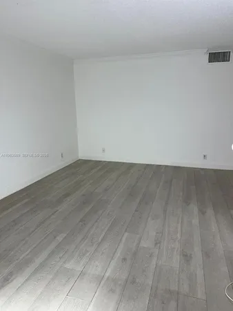 wooden floor in a white room