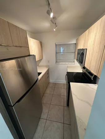 a kitchen with stainless steel appliances a refrigerator sink and stove