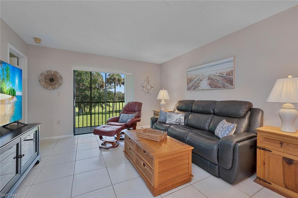 4258 27th Court Southwest, Unit 203 Naples, FL 34116 - Photo 2 of 15 View of tiled living room