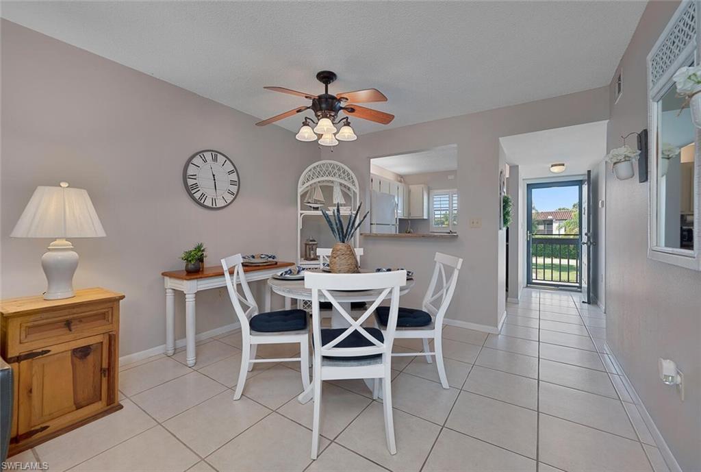 4258 27th Court Southwest, Unit 203 Naples, FL 34116 - Photo 6 of 15 Tiled dining space with ceiling fan
