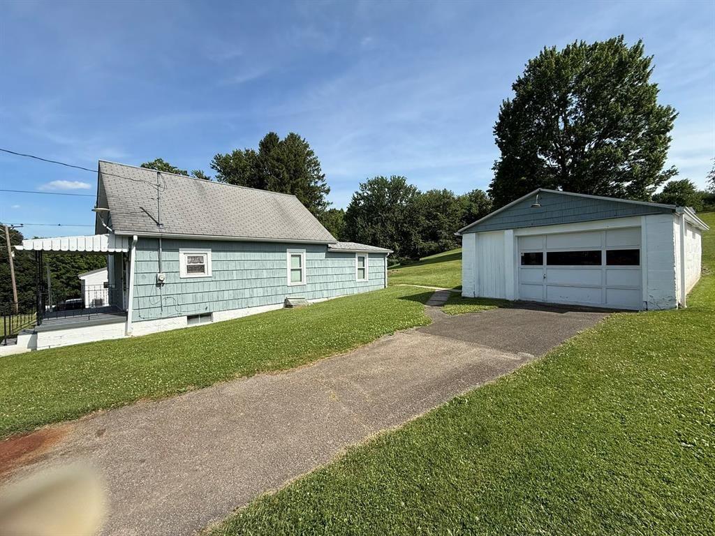222 Bagdad Road Leechburg, PA 15656 - Photo 5 of 23 a front view of a house with a yard and garage