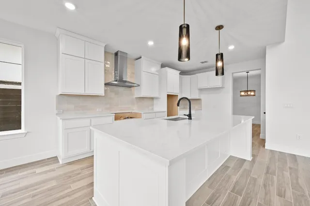 a kitchen with kitchen island a sink a stove and a refrigerator