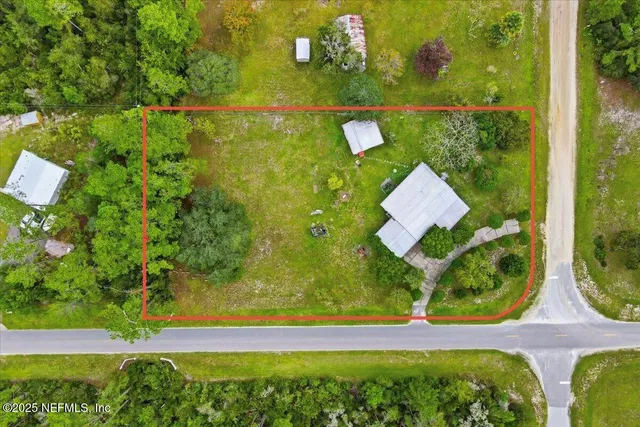 an aerial view of a house with yard swimming pool and outdoor seating