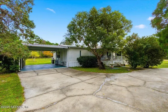 a view of a house with a backyard