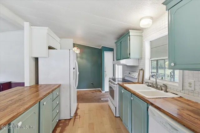 a view of kitchen with kitchen island a sink and a stove