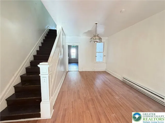 wooden floor in an empty room with stairs