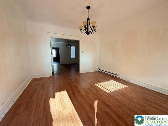 a view of a room with wooden floor and staircase