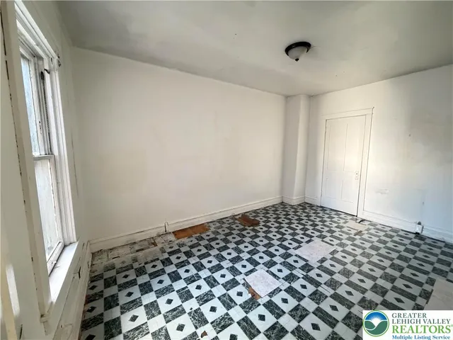 a bathroom with a black and white checkered floor