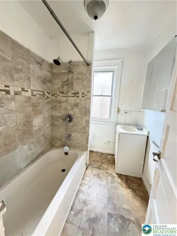 a bathroom with a bathtub and a shower