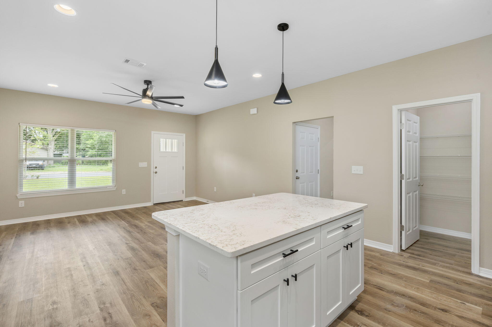 1357 East Chestnut Avenue Crestview, FL 32539 - Photo 15 of 37 a room with a bed and a chandelier