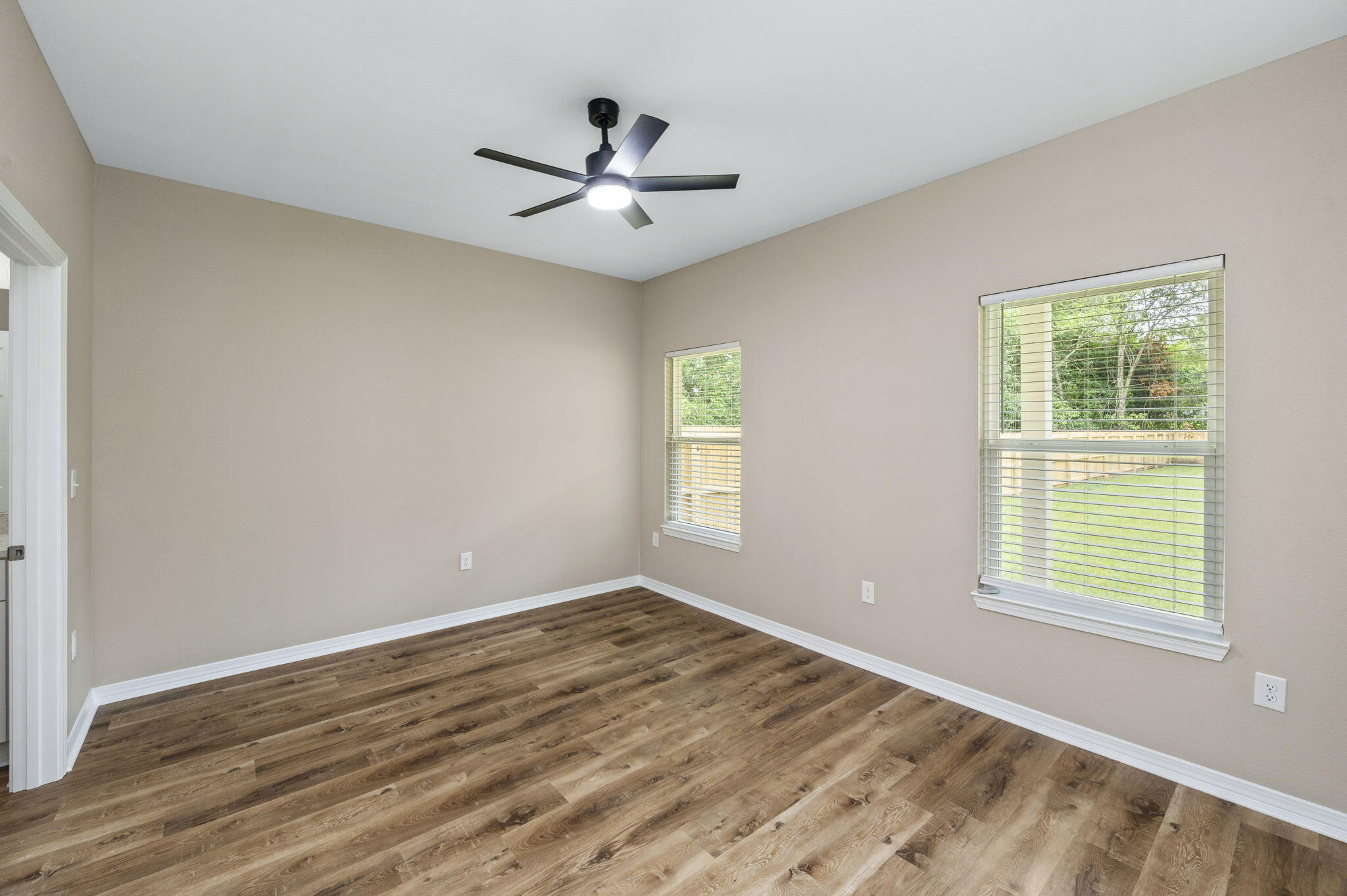 1357 East Chestnut Avenue Crestview, FL 32539 - Photo 18 of 37 a view of empty room with wooden floor and fan