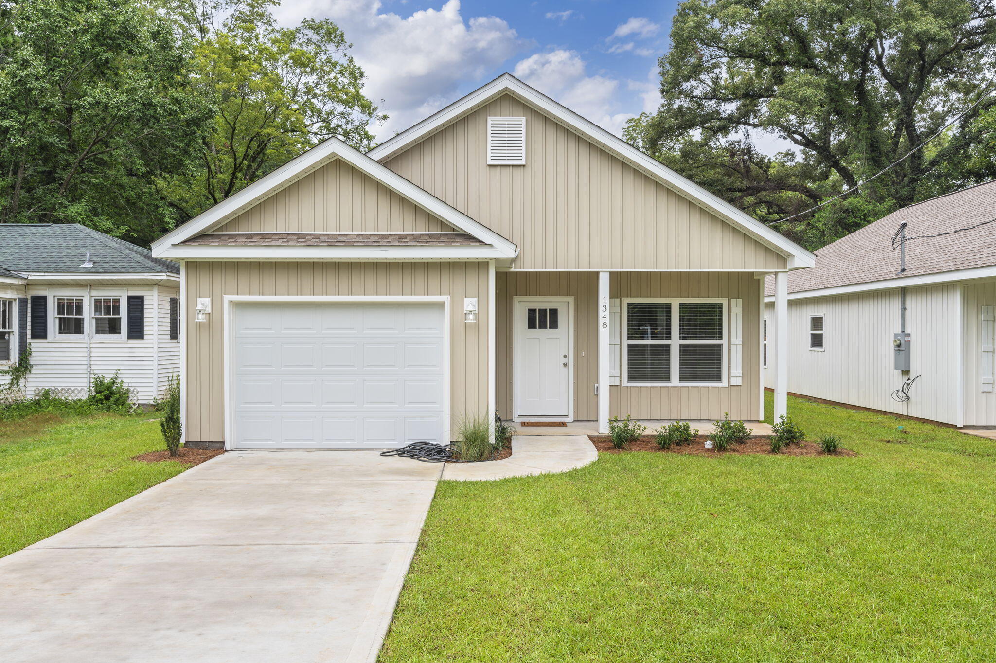 1357 East Chestnut Avenue Crestview, FL 32539 - Photo 2 of 37 a front view of a house with a yard and garage