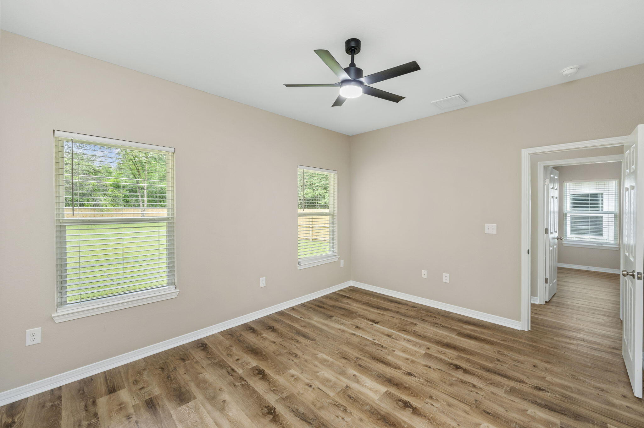 1357 East Chestnut Avenue Crestview, FL 32539 - Photo 21 of 37 a view of a big room with wooden floor and windows