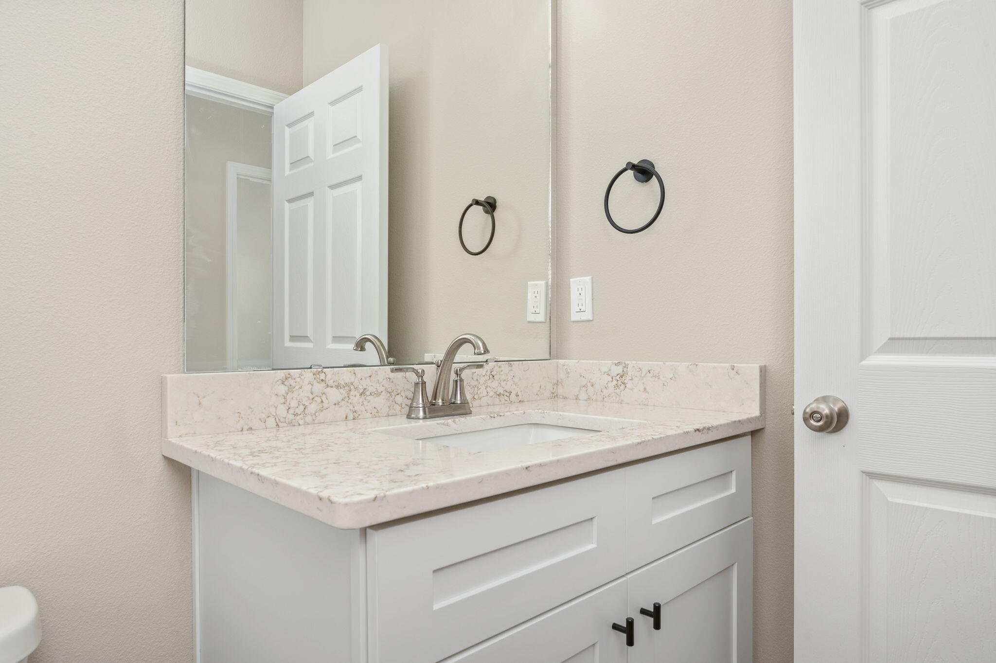 1357 East Chestnut Avenue Crestview, FL 32539 - Photo 30 of 37 a bathroom with a granite countertop sink and a mirror