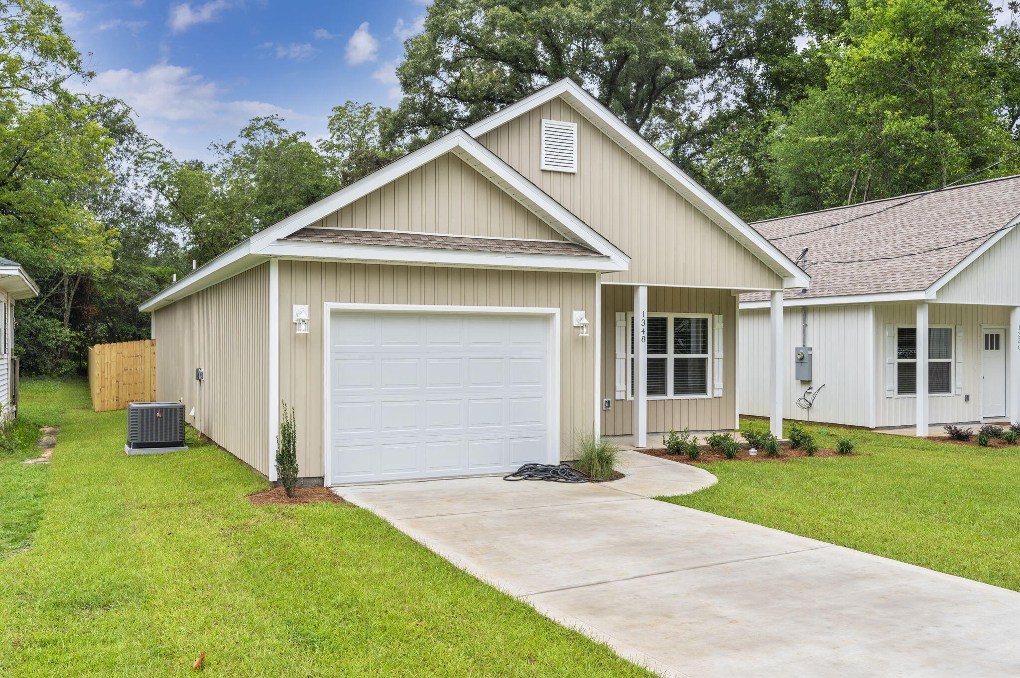 1357 East Chestnut Avenue Crestview, FL 32539 - Photo 3 of 37 a front view of a house with a yard and garage