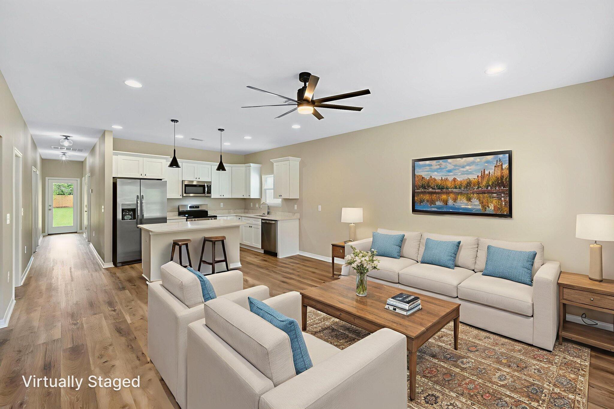1357 East Chestnut Avenue Crestview, FL 32539 - Photo 7 of 37 a living room with furniture kitchen view and a chandelier