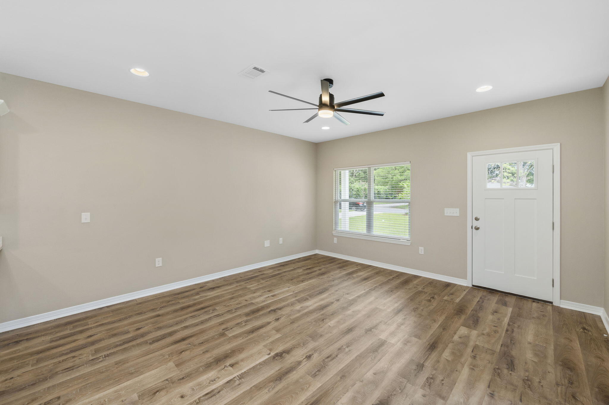 1357 East Chestnut Avenue Crestview, FL 32539 - Photo 10 of 37 wooden floor in an empty room with a window