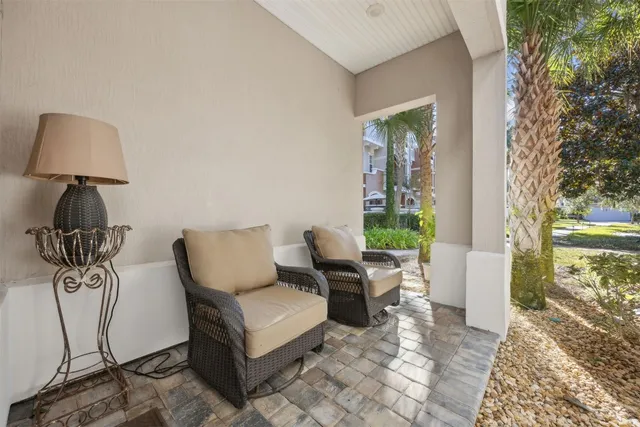 a living room with furniture or chandelier and a wooden floor