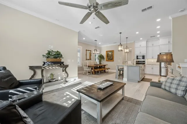 a view of a fountain in front of a house with large trees