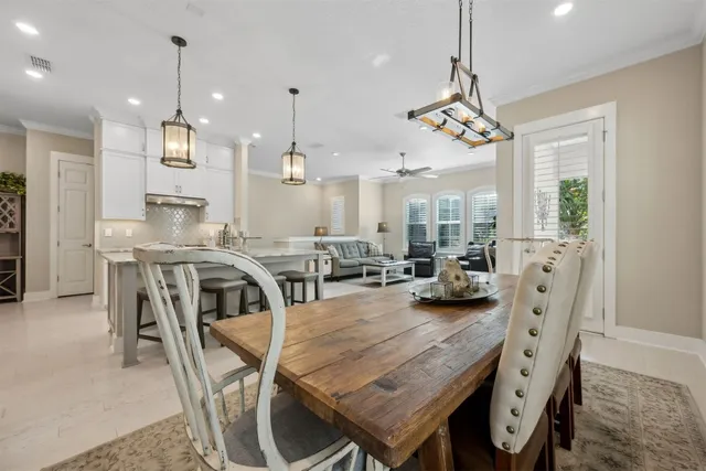 an aerial view of residential houses with outdoor space and trees