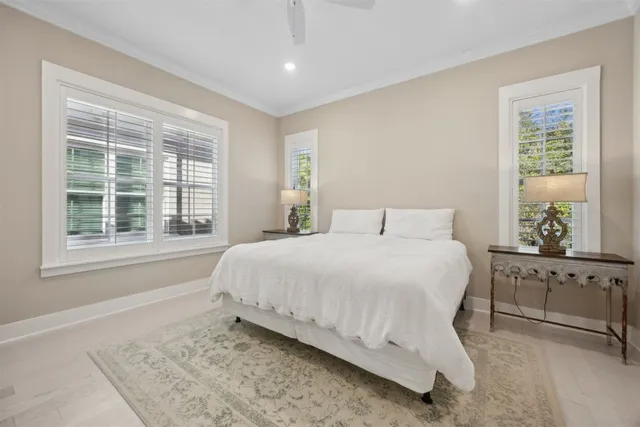 a view of sign board with flower plants and wooden fence