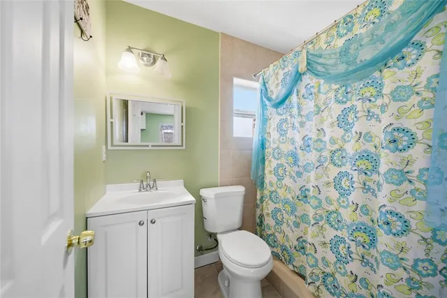 a bathroom with a shower and a toilet