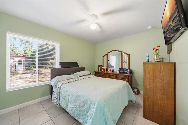 a bedroom with a bed and a window