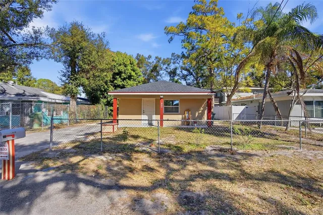 a backyard of a house with barbeque oven table and chairs