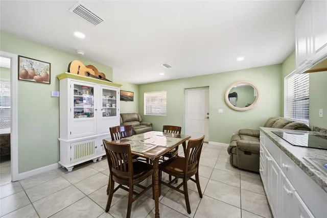 a view of a dining room with furniture and a chandelier