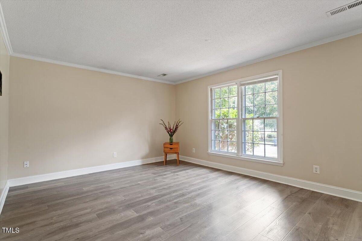 5309 Covey Court Raleigh, NC 27609 - Photo 15 of 47 an empty room with wooden floor and windows