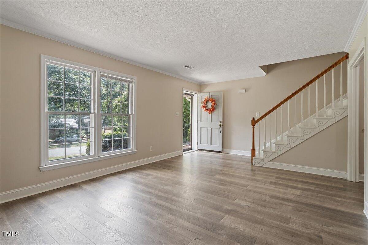 5309 Covey Court Raleigh, NC 27609 - Photo 16 of 47 a view of an entryway with wooden floor