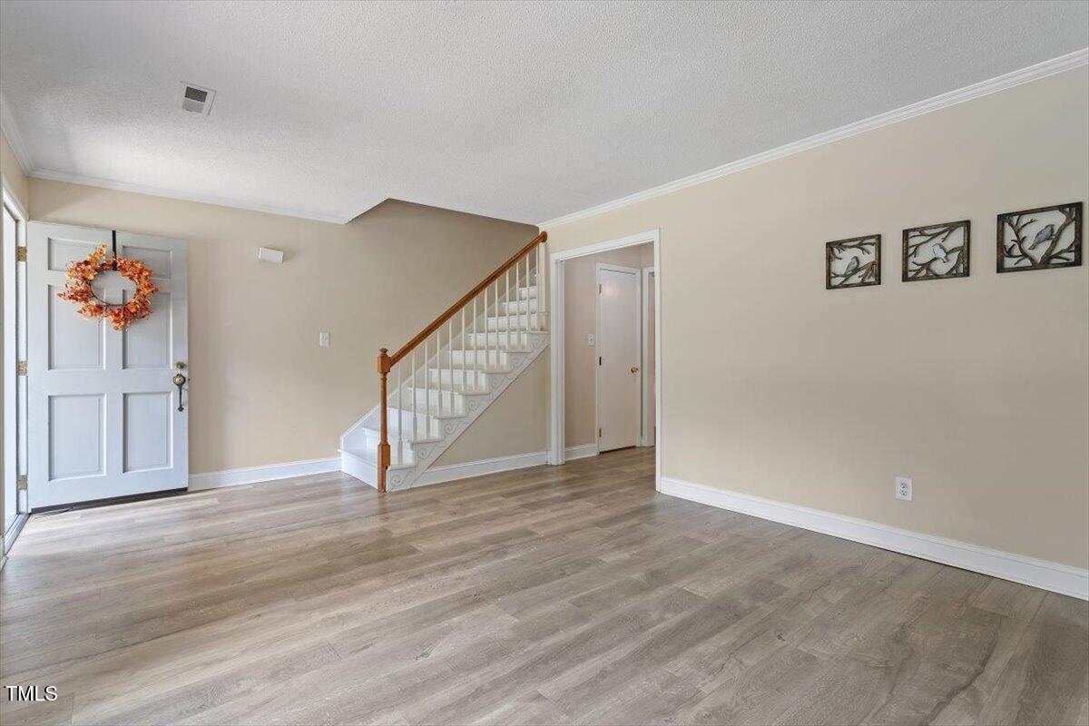 5309 Covey Court Raleigh, NC 27609 - Photo 17 of 47 a view of an empty room with wooden floor
