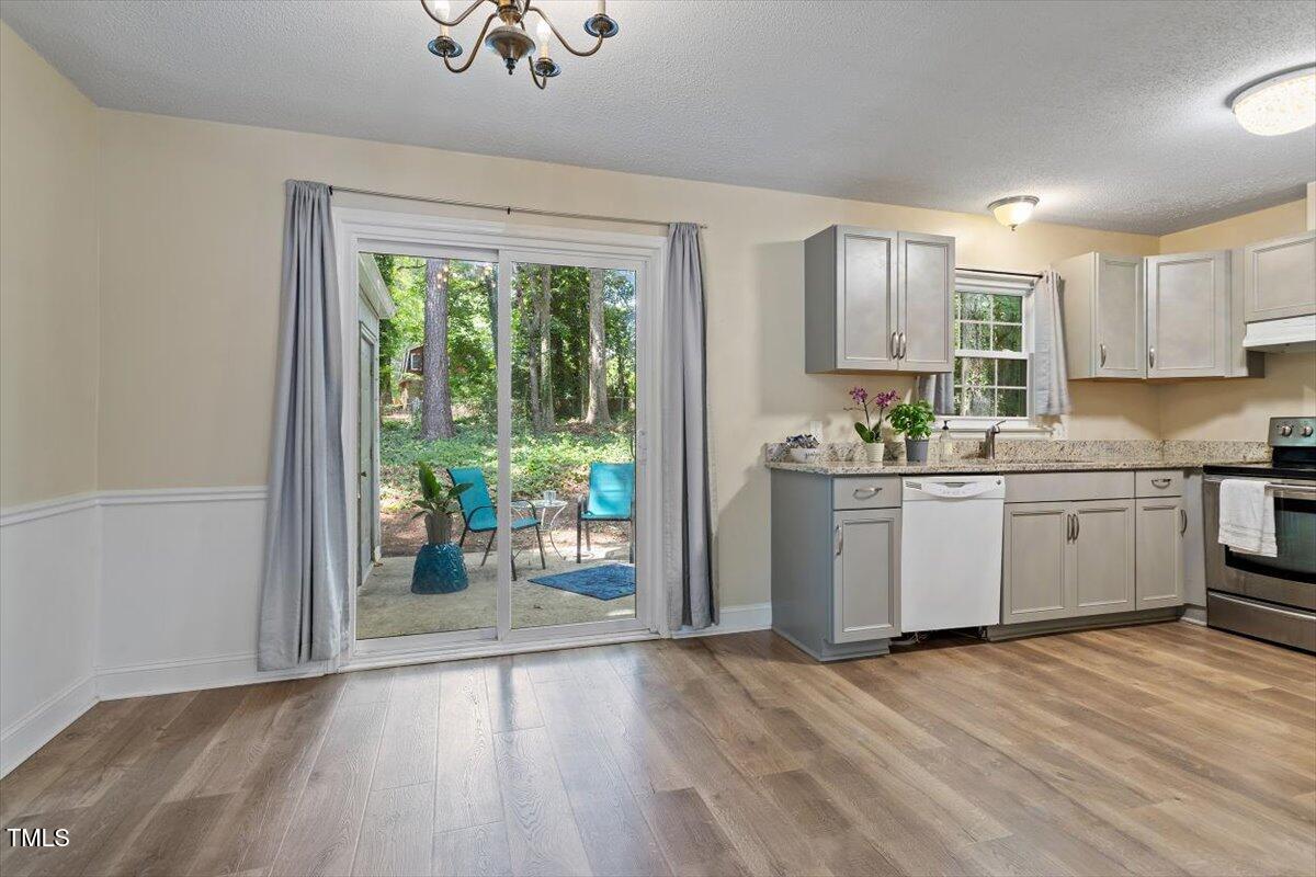 5309 Covey Court Raleigh, NC 27609 - Photo 19 of 47 a kitchen with a sink window and cabinets