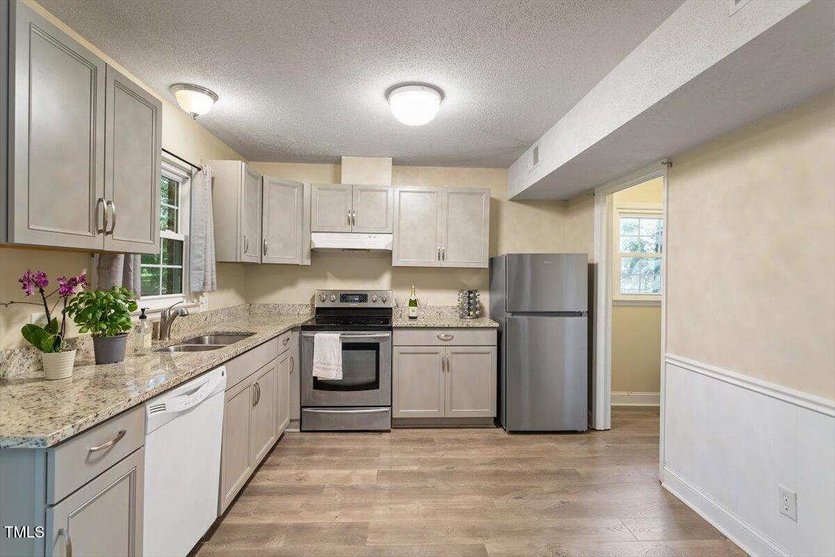 5309 Covey Court Raleigh, NC 27609 - Photo 21 of 47 a kitchen with a sink stove and refrigerator