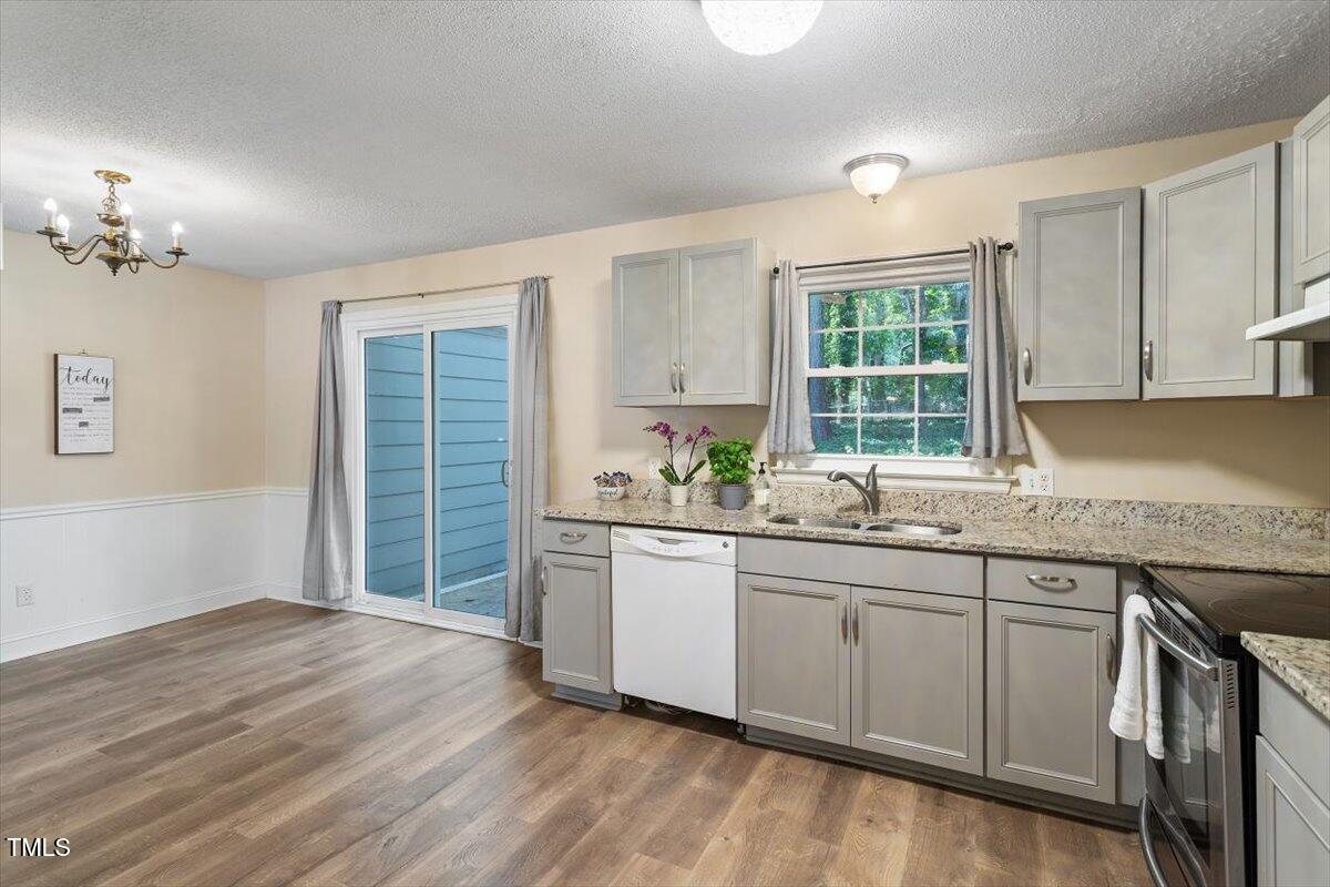 5309 Covey Court Raleigh, NC 27609 - Photo 23 of 47 a kitchen with granite countertop a sink and cabinets