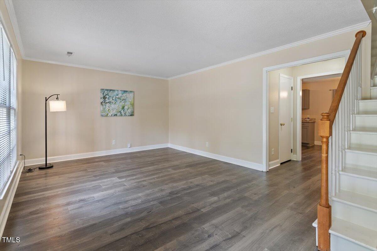 5309 Covey Court Raleigh, NC 27609 - Photo 29 of 47 a view of an empty room with wooden floor and a window