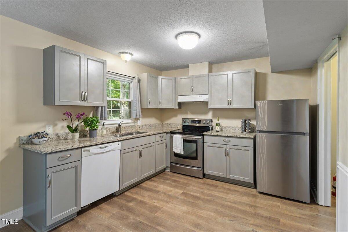 5309 Covey Court Raleigh, NC 27609 - Photo 2 of 47 a kitchen with stainless steel appliances granite countertop a refrigerator sink and stove